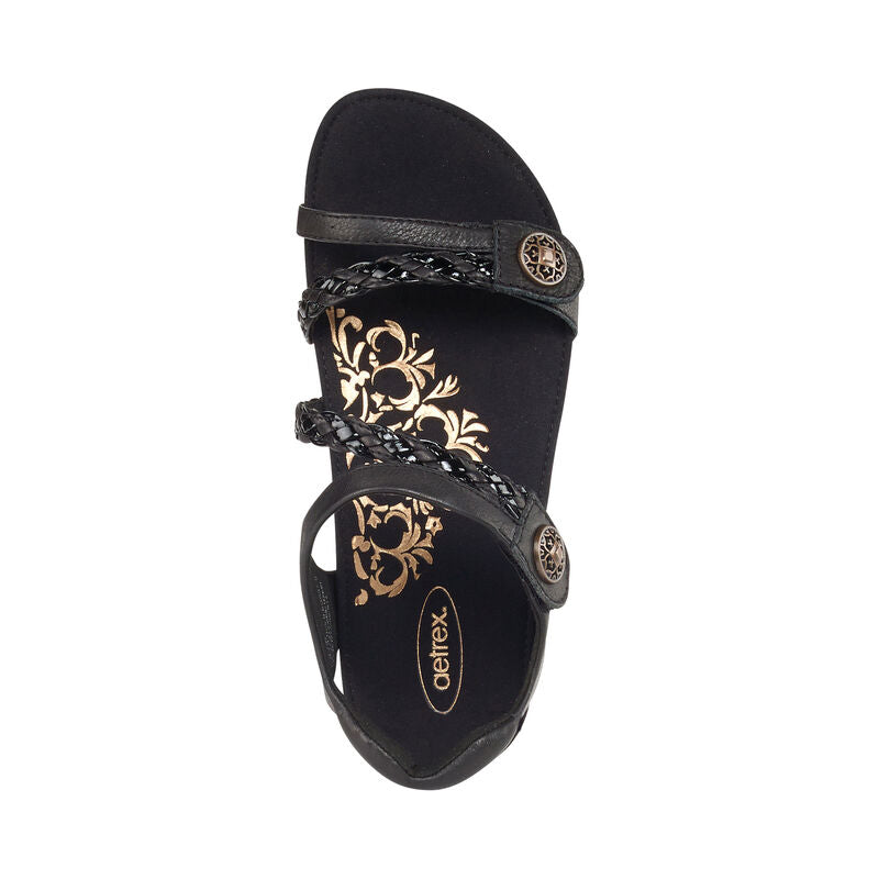 Aetrex Jillian sandal in black with braided straps and gold floral footbed design.