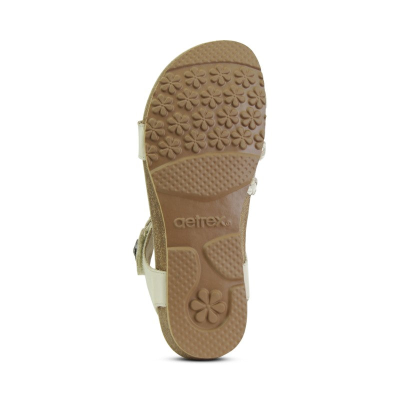 Aetrex Jillian casual sandal outsole in beige with flower pattern and textured grip.