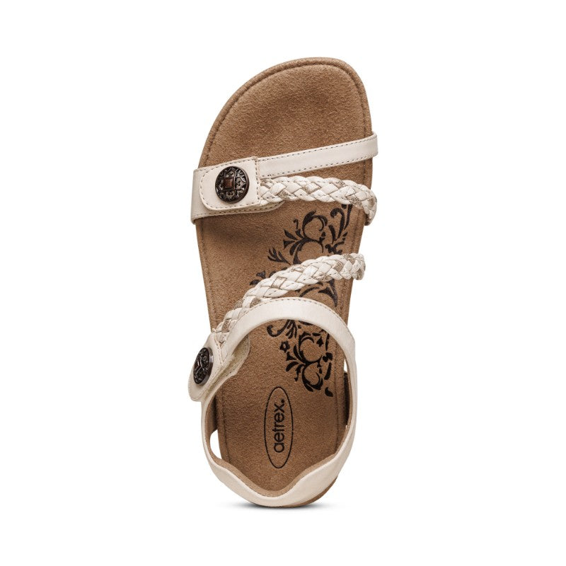 Aetrex Jillian casual sandal in beige with braided straps and floral-inlaid footbed.