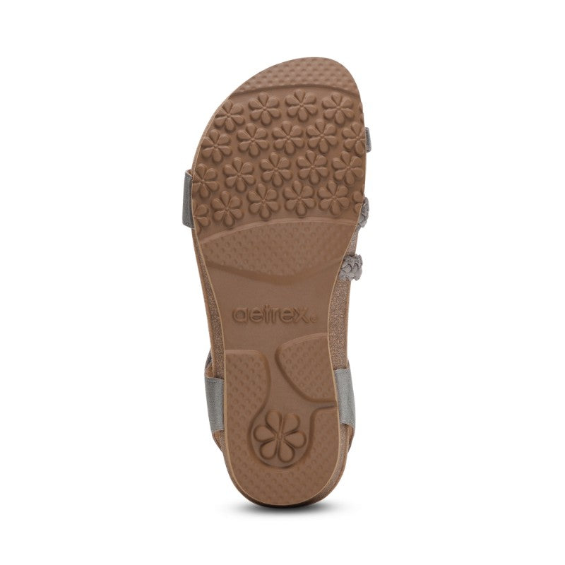 Aetrex Jillian casual sandal with tan sole and gray straps featuring flower-pattern tread.
