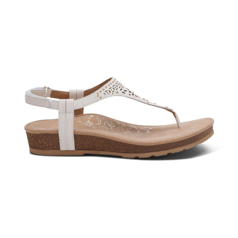 Aetrex Evelyn casual sandal with white strappy upper, decorative cutouts, and cork wedge sole